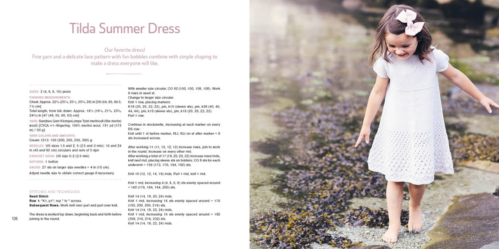 A girl wears a white dress featuring Scandinavian knitting patterns from "Summer Knitting for Little Sweethearts" by Schiffer Publishing, Ltd., crafted with soft merino wool yarn.