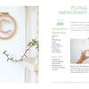 The Little Book of Flower Pressing by Schiffer Publishing, Ltd. features an embroidery hoop with pressed flowers, displayed on a white wall above a plant, and includes step-by-step photos and a materials list for your own floral embroidery project.