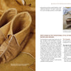 Schiffer Publishing, Ltd.’s “Natural Leather Tanning” is shown with handmade moccasins featuring gathered top stitching and a selection of awls, all set on tan hide that reveals the detailed grain of natural tanning.