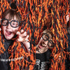 Three people wearing black shirts and playful Halloween glasses pose with clawed hands among orange and black streamers, showing off creative Halloween decor inspired by Schiffer Publishing, Ltd.'s "How to Haunt Your House Halloween Craft Fun.