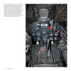 Cockpit view of the F8F Bearcat by Schiffer Publishing, Ltd. shows gauges, switches, central control stick, and rudder pedals on the instrument panel of this carrier-based fighter aircraft.